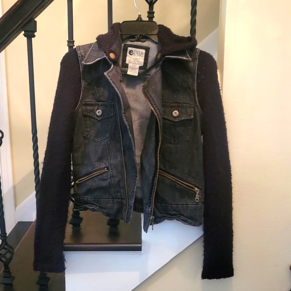 Jean jacket with black sweater sleeves and hood. Size small.